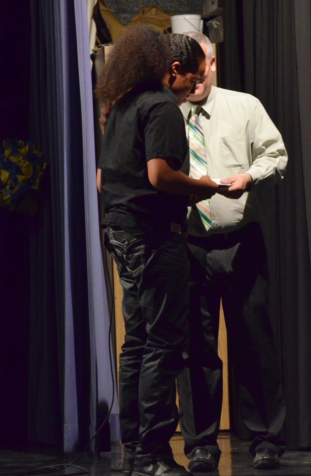 Sione Fungalei receives his Principal's Award from Mr. Sites.