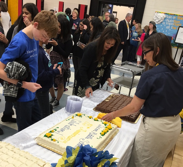 Students, new and old, enjoying commemorative cake dished out by Holly Tippets.